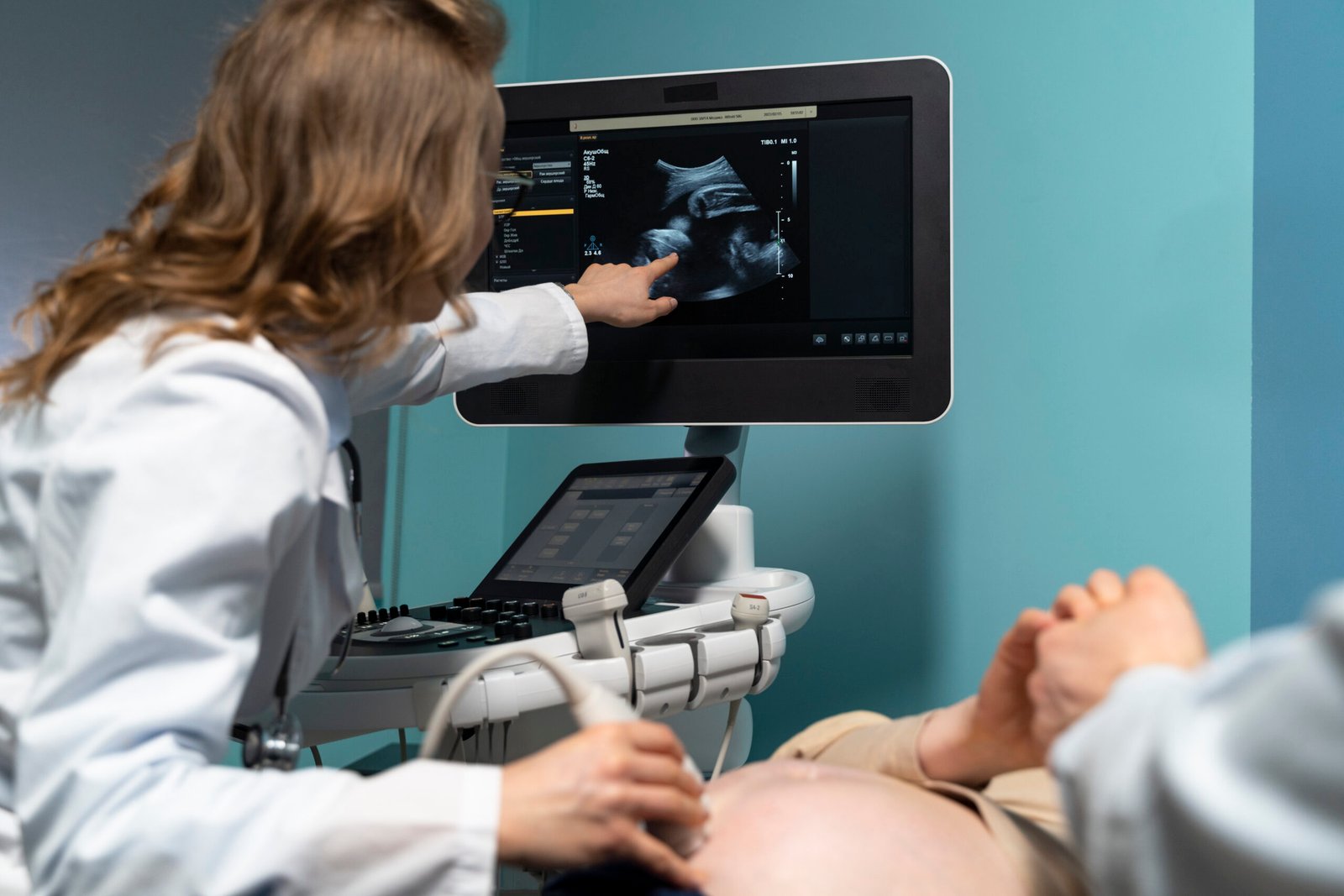 gynecologist performing ultrasound consultation scaled