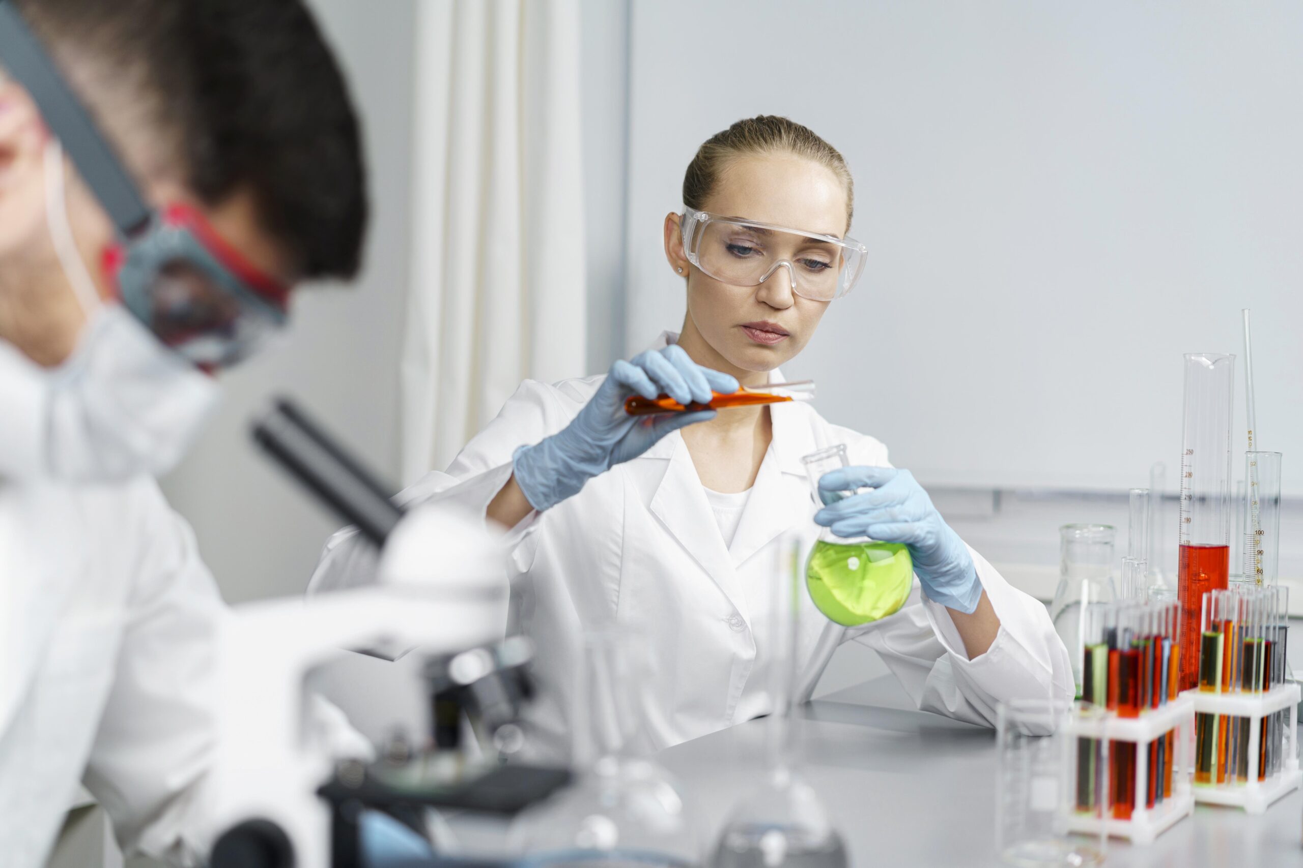 female-researcher-laboratory-with-test-tubes-male-colleague